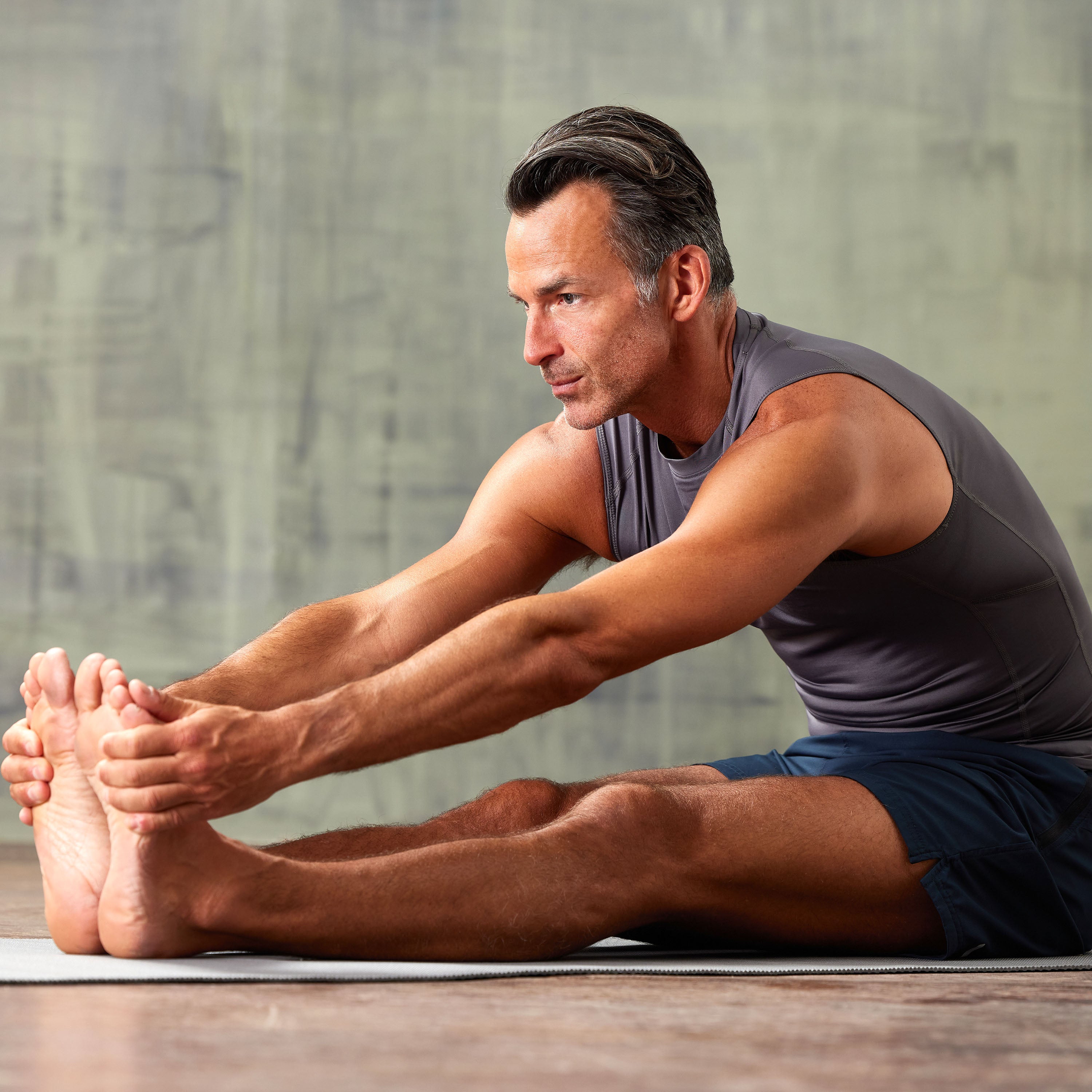 Person doing a front forward extended leg bend of Yoga Mat